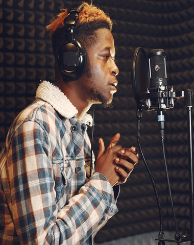 singing and working in a studio with a microphone